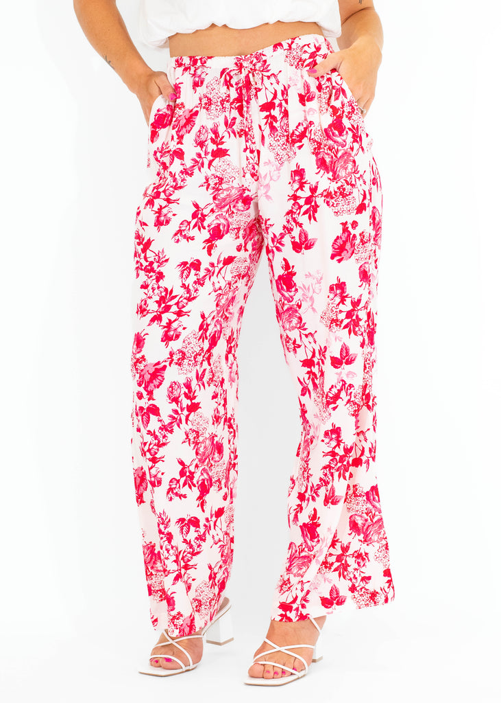 white flowy pants with pink floral pattern